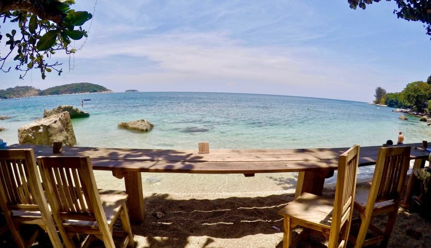 An outdoor dining area with a beach view.