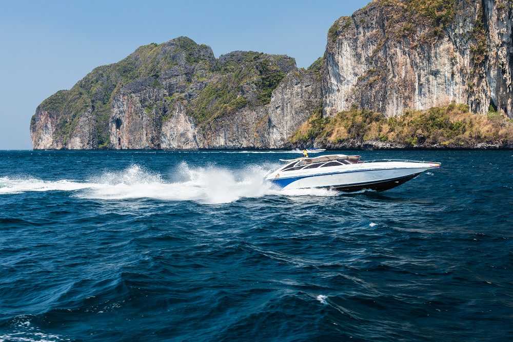 Speedboat in Phi Phi Islands with limestone cliffs in the background