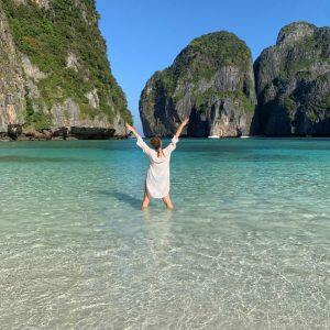 Woman standing in the calm waters of Maya Bay