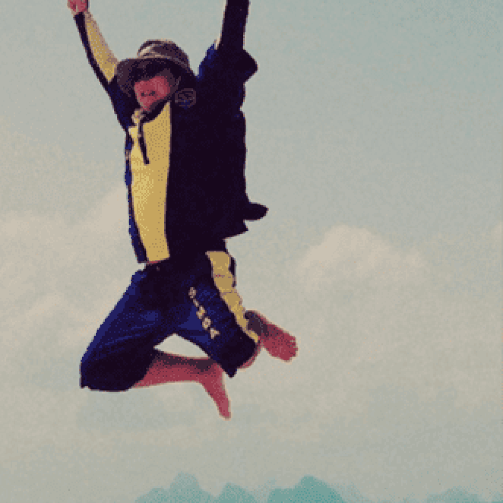 A man with goggles jumping on the shore