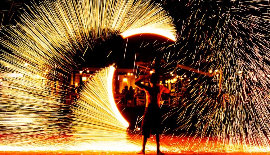 Fire show performance on a beach at night