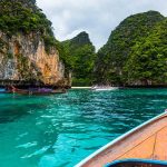 Scenic island landscape with boats and clear blue water