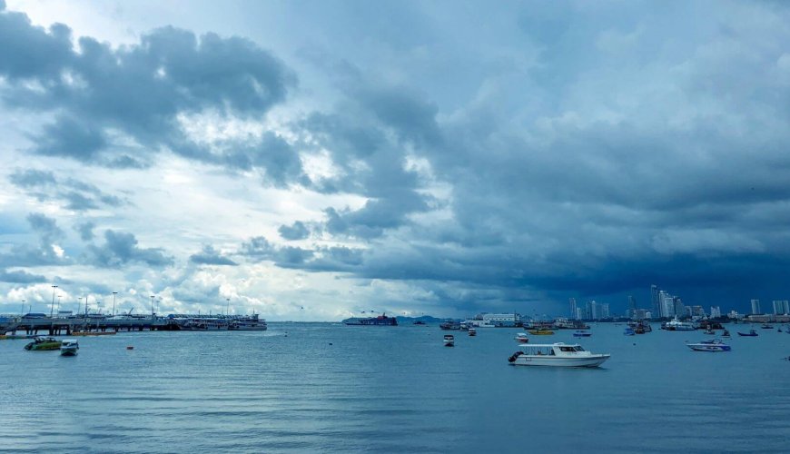 A beautiful shot over the Andaman Sea with boats in the foreground and cloudy skies in the background