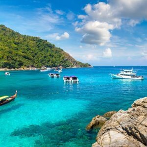 boats anchored in the shallow waters at koh rachai yai